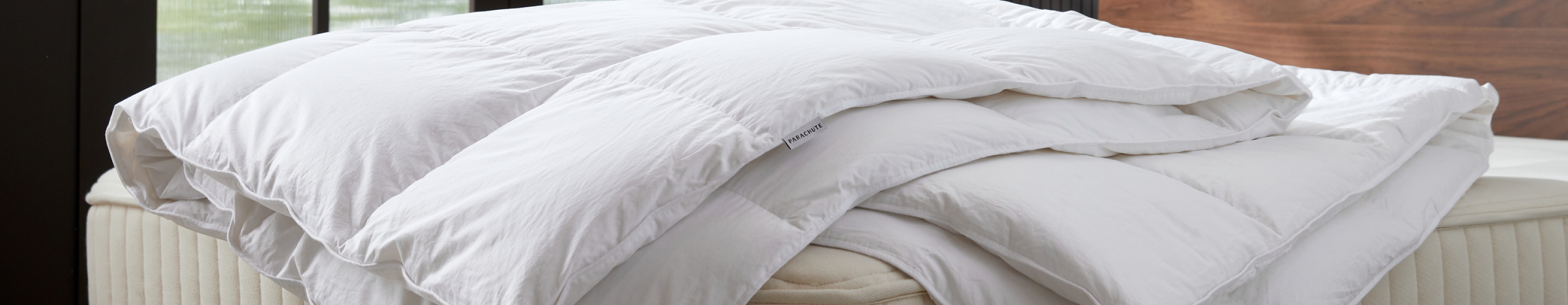 A fluffy white duvet sits atop a mattress