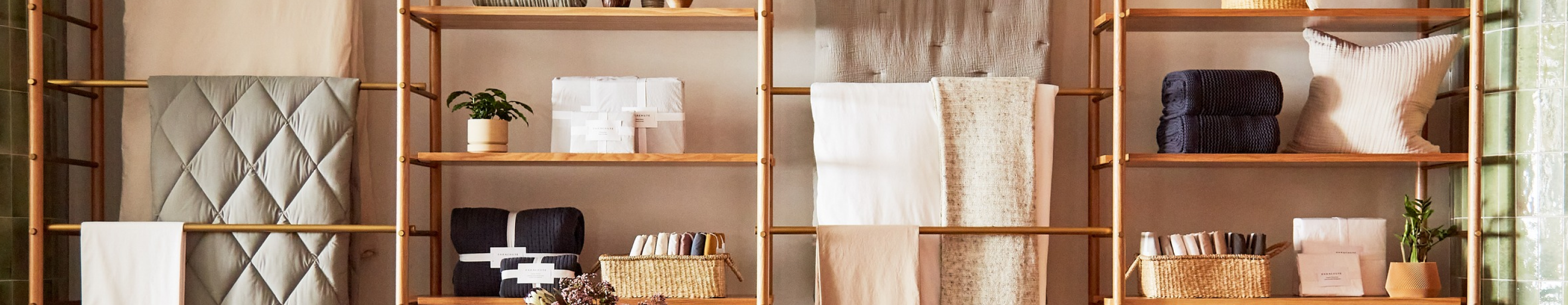 A retail store display showing home goods like towels, blankets and decor. 